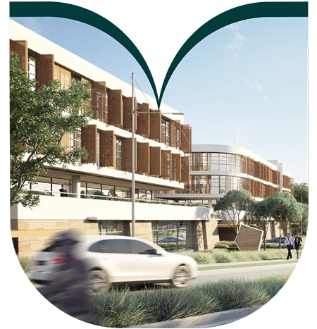 Modern multi-storey building with large windows and wood accents, cars and pedestrians on the street, trees and greenery in the foreground, clear sky above—an impressive example of urban architecture that reflects the evolving landscape of Sydney homesites and showcases the potential of new land development.