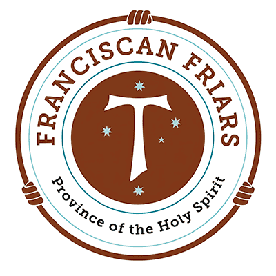 Circular logo with “Franciscan Friars Province of the Holy Spirit” text, a Tau cross in the centre, and five stars on a brown background, bordered by hands grasping the circle—a symbol of unity and welcome that reflects values cherished in new land development projects such as Sydney homesites or recent land release Cambelltown initiatives.